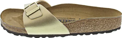 Side view of a single gold Birkenstock sandal.