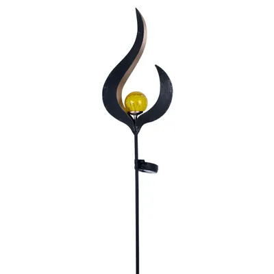 A solar garden light with a flame-like design and a yellow glass orb.