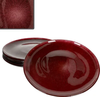 A stack of red glass plates with a textured pattern, with one plate in the foreground.