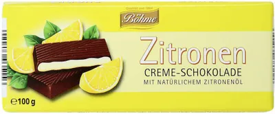 A chocolate bar with lemon slices and leaves on a yellow background.