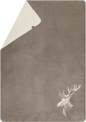 A blanket folded to show two sides, with a deer head graphic on one side.