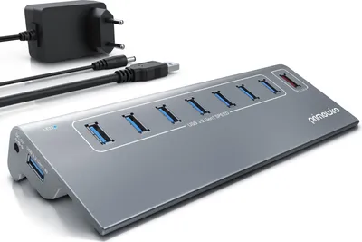 A gray USB hub with multiple ports and a power adapter are shown on a white background.