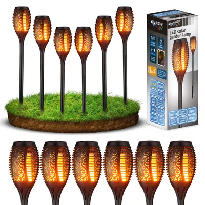 A set of solar garden lamps with a flame effect, displayed on a patch of grass, next to their packaging.