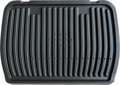 A top-down view of a black grill plate with raised ridges and small holes.