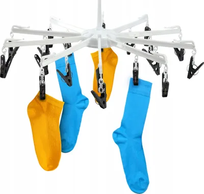 A white clothes drying rack with socks clipped to it.