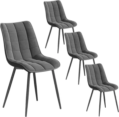 Four dark gray upholstered dining chairs with black metal legs are arranged on a white background.