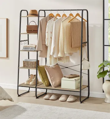 A clothing rack with clothes, accessories, and shoes displayed on shelves in a room.