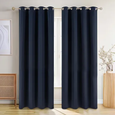 Two navy blue curtains hanging on a curtain rod in front of a window, with a piece of furniture to the left and a decorative stand with a plant to the right.