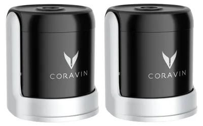 Two black and silver Coravin wine stoppers are shown side-by-side against a white background.