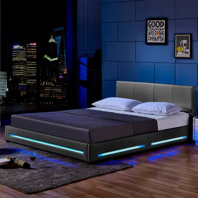 A modern bedroom with a city skyline view at night, featuring a bed with LED lighting.