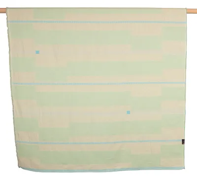 A blanket is hung on a wooden rod.