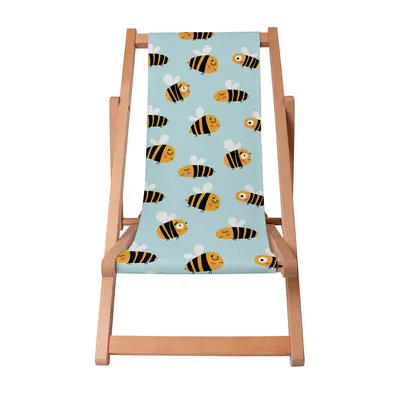 A wooden deck chair with a light blue fabric featuring a pattern of cartoon bees.