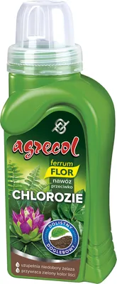 A green bottle of plant fertilizer with a label showing text and images of plants.