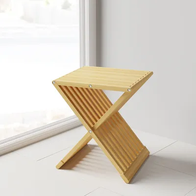 A wooden stool is placed near a window.
