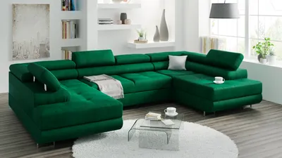 A spacious living room with a large green sectional sofa as the focal point.