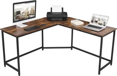 An L-shaped desk with a computer monitor, keyboard, mouse, printer, laptop, and a book.