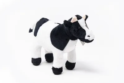 A stuffed toy cow is shown against a white background.