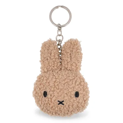 A fluffy beige Miffy keychain is shown against a white background.