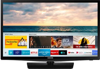 A Samsung TV displaying a streaming service interface with various movie and TV show thumbnails.