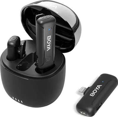 A set of wireless microphones and their charging case are displayed against a white background.