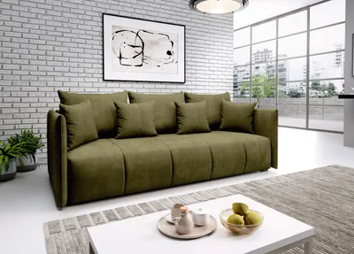 A modern living room with a green sofa, a white coffee table, and a large window overlooking a city.