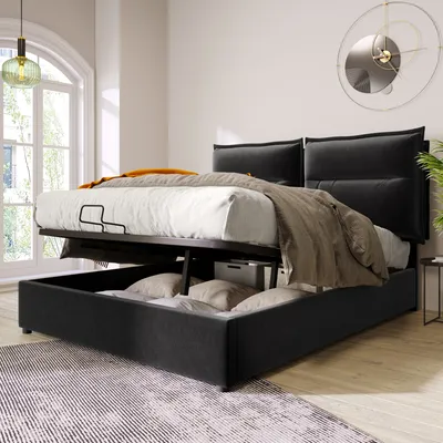 A black upholstered bed with its storage compartment open, revealing pillows and storage boxes inside. The bed is set in a well-lit room with a large window and a decorative clock on the wall.