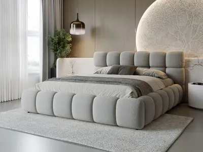 A modern bedroom with a large upholstered bed as the focal point.