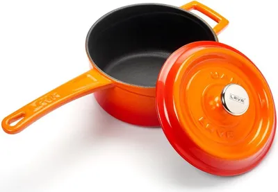 An orange cast iron pot with its lid slightly ajar, displayed on a white background.
