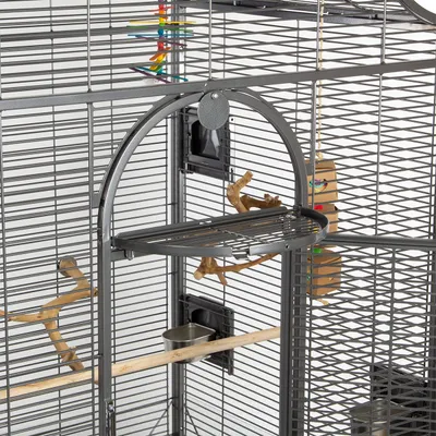 A close-up view of a large bird cage with perches and toys.