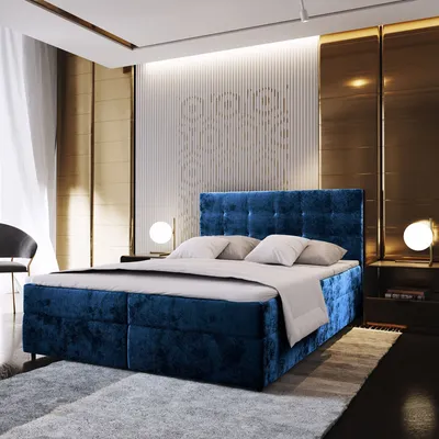 A luxurious bedroom with a large blue upholstered bed as the focal point.