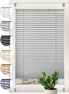 A product image showing a gray pleated blind with swatches of other colors on the left side, and a potted plant in the foreground.