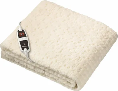 A folded cream-colored electric blanket with a control unit attached.