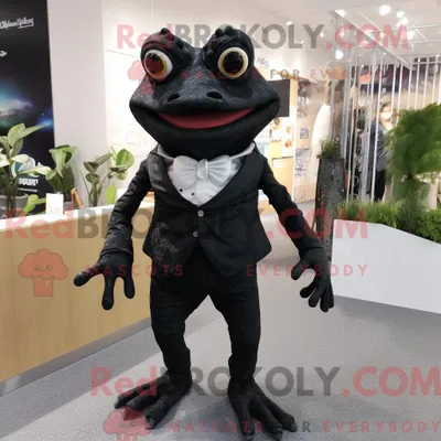 Obrázek produktu pro Postava REDBROKOLY maskota černé žáby oblečená s kalhotami a sponkami do vlasů