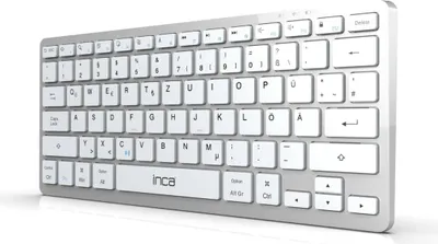 A silver and white keyboard is shown from a low angle, angled to the right.