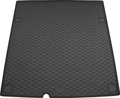 A black rubber car trunk mat with a hexagonal pattern.