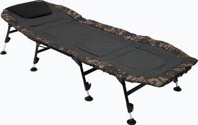 A camouflage fishing bedchair with a black pillow, shown from a side angle on a white background.