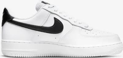 A white Nike Air Force 1 '07 sneaker with black accents, shown from the side on a white background.