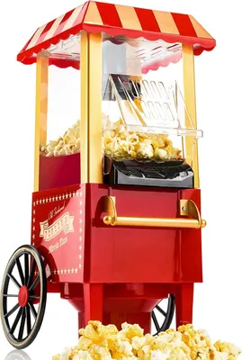 A red and gold retro-style popcorn machine filled with popcorn, with popcorn spilled around the base.