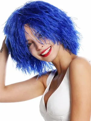 A woman wearing a blue wig and a white top, posing against a white background.