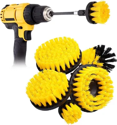A yellow and black power drill with a brush attachment, surrounded by several yellow and black brush heads.