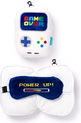 A white background displays two travel accessories: a pillow shaped like a game controller and an eye mask with a power bar graphic.