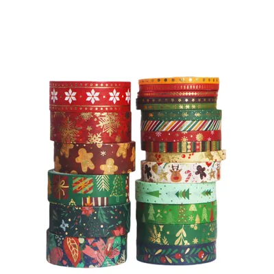 Two stacks of Christmas-themed washi tape rolls against a white background.