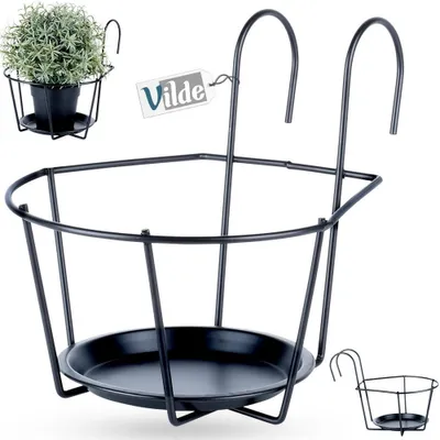 A black metal balcony railing planter holder is shown with a small plant in a pot in the upper left corner. A tag with the brand name 'Vilde' is also visible.