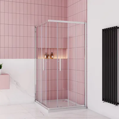 A modern bathroom with pink tiled walls and a glass shower enclosure.
