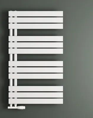 A white radiator is mounted on a gray wall.