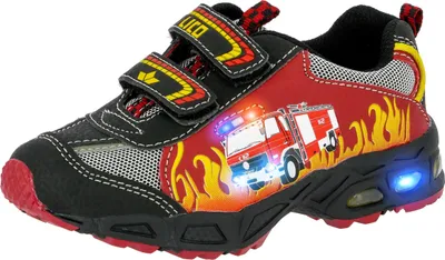 A single child's shoe with a fire truck design and flashing lights.