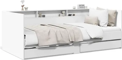 A white daybed with drawers and a shelf unit above it, shown with bedding and pillows.