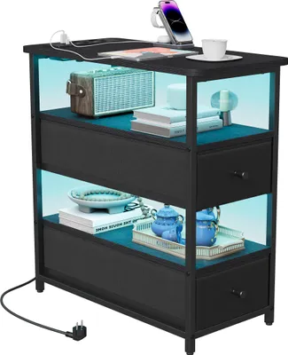 A black nightstand with LED lighting, featuring shelves, drawers, and a charging station with a phone and cup.