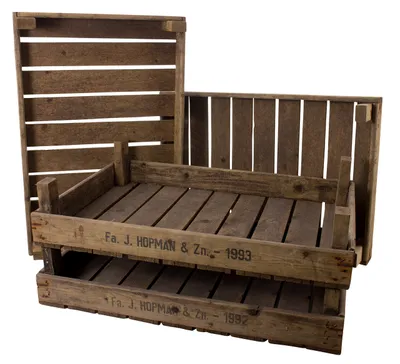 Three wooden crates are stacked and arranged in a way that suggests they are for display or storage.