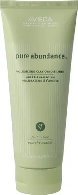 A product shot of a green squeeze bottle of Aveda Pure Abundance Volumizing Clay Conditioner.